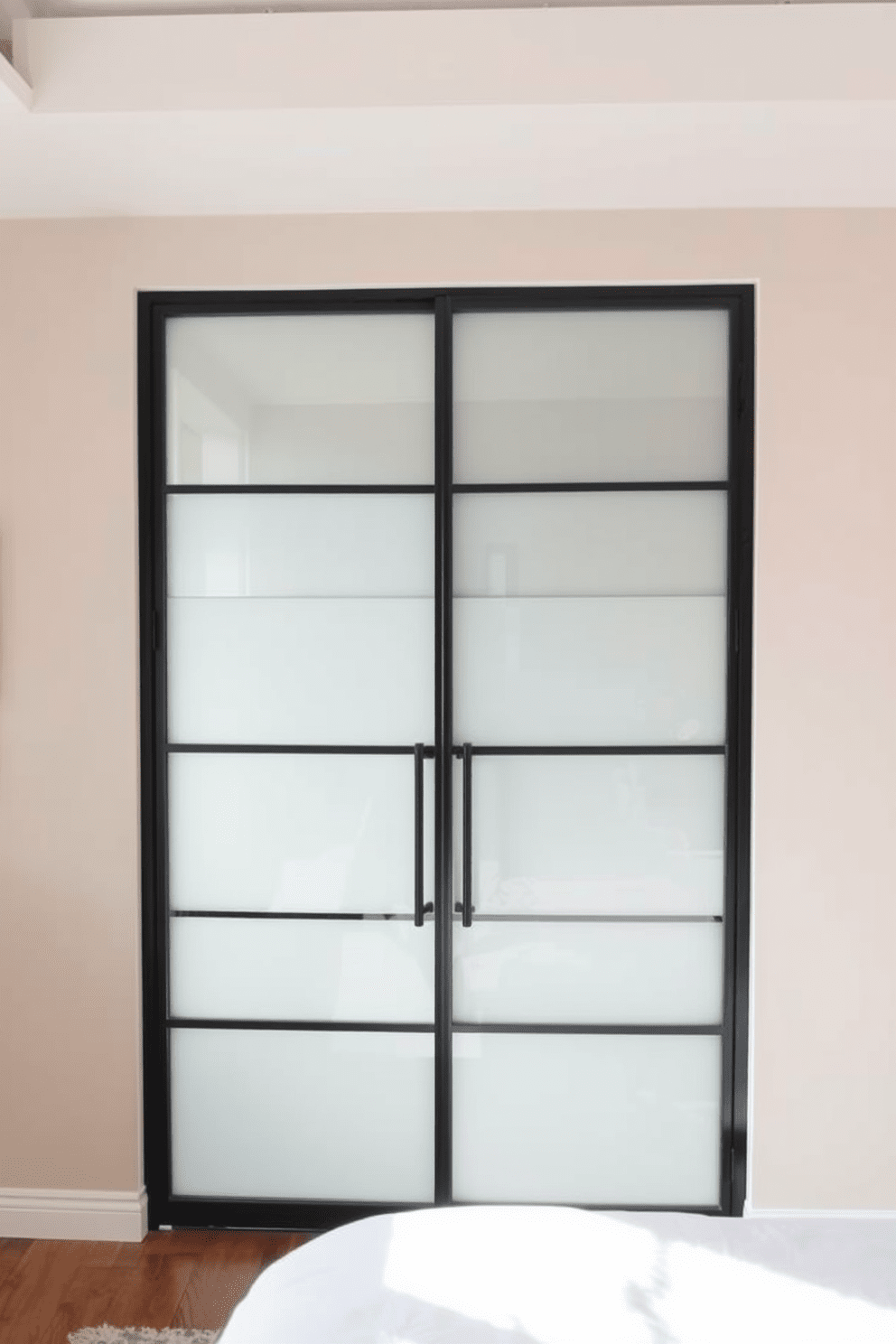 A contemporary bedroom door featuring frosted glass panels that allow natural light to filter in while maintaining privacy. The door frame is crafted from sleek black metal, contrasting beautifully with the soft tones of the surrounding walls.