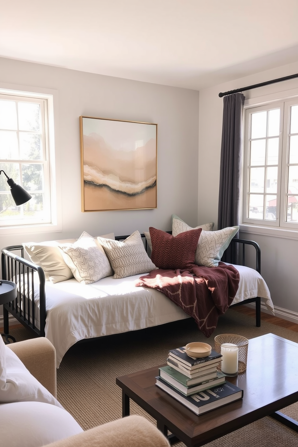 A cozy bedroom living room combo featuring a stylish daybed positioned against a wall adorned with soft, neutral-toned artwork. The space is illuminated by natural light streaming through large windows, creating a warm and inviting atmosphere. Plush throw pillows in various textures are scattered across the daybed, inviting relaxation and casual lounging. A small coffee table sits nearby, topped with a stack of books and a decorative candle, enhancing the room's functionality and charm.