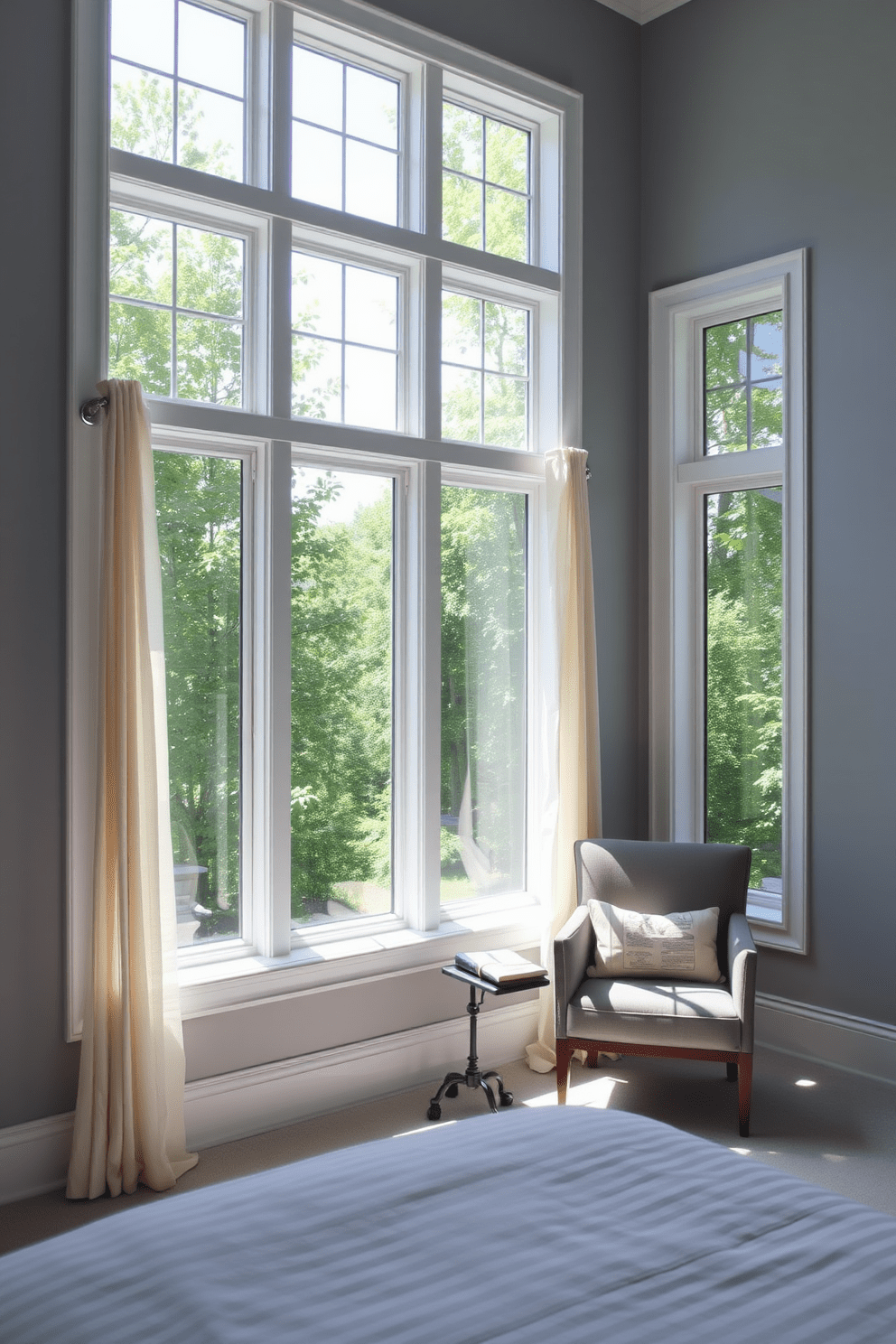 A serene bedroom featuring large energy-efficient windows that flood the space with natural light. The windows are framed in sleek white wood, complementing the soft gray walls and offering views of lush greenery outside. The window treatments consist of light, flowing sheer curtains that add a touch of elegance while maintaining privacy. A cozy reading nook is positioned by the window, complete with a comfortable chair and a small side table for books and drinks.