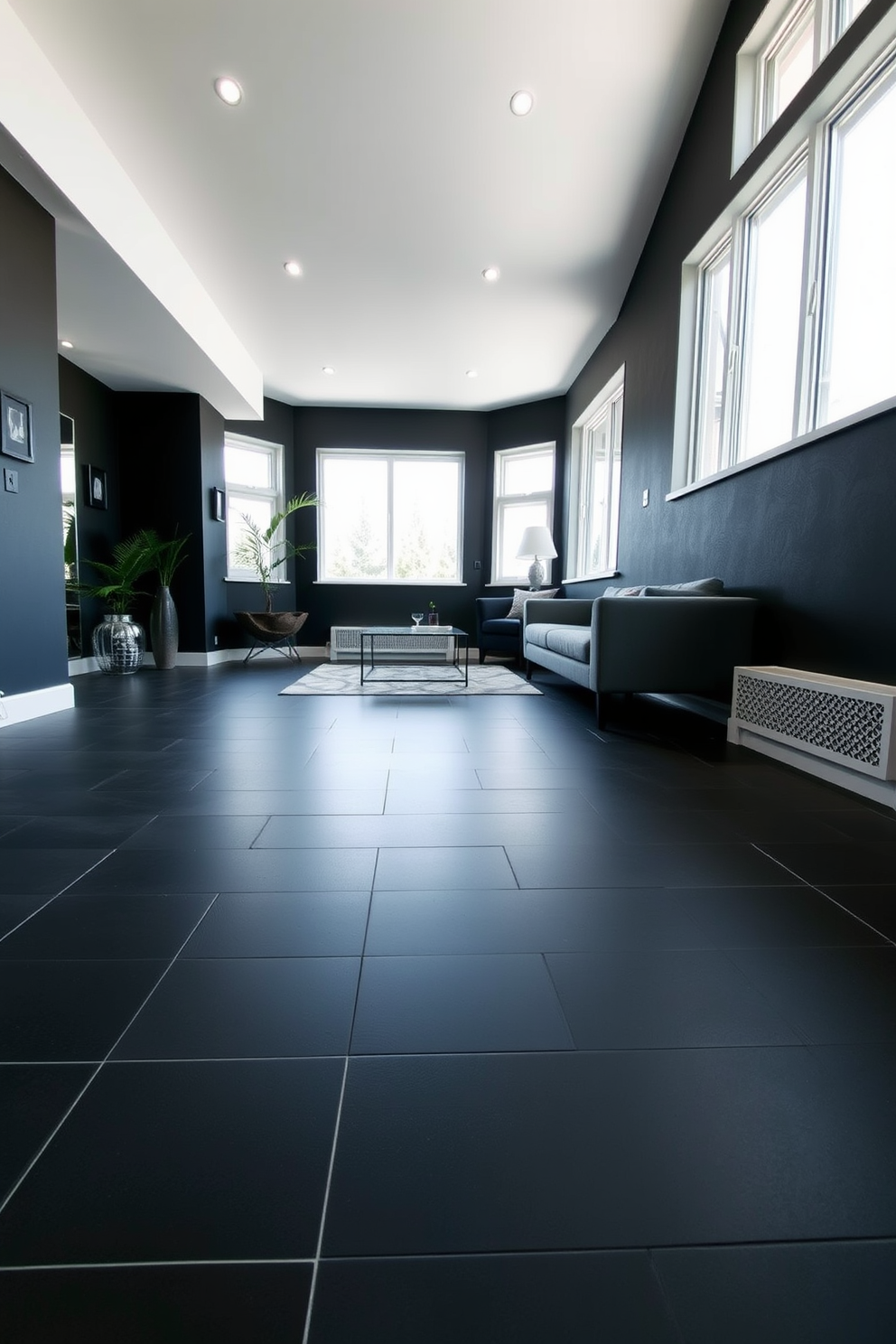 A modern basement featuring dark tile flooring that provides a sleek and sophisticated look. The space is enhanced by underfloor heating, ensuring comfort during colder months while maintaining a stylish aesthetic. The walls are painted in a deep charcoal hue, creating a cozy atmosphere. Large windows allow natural light to flood the room, highlighting the contemporary furnishings and decor.