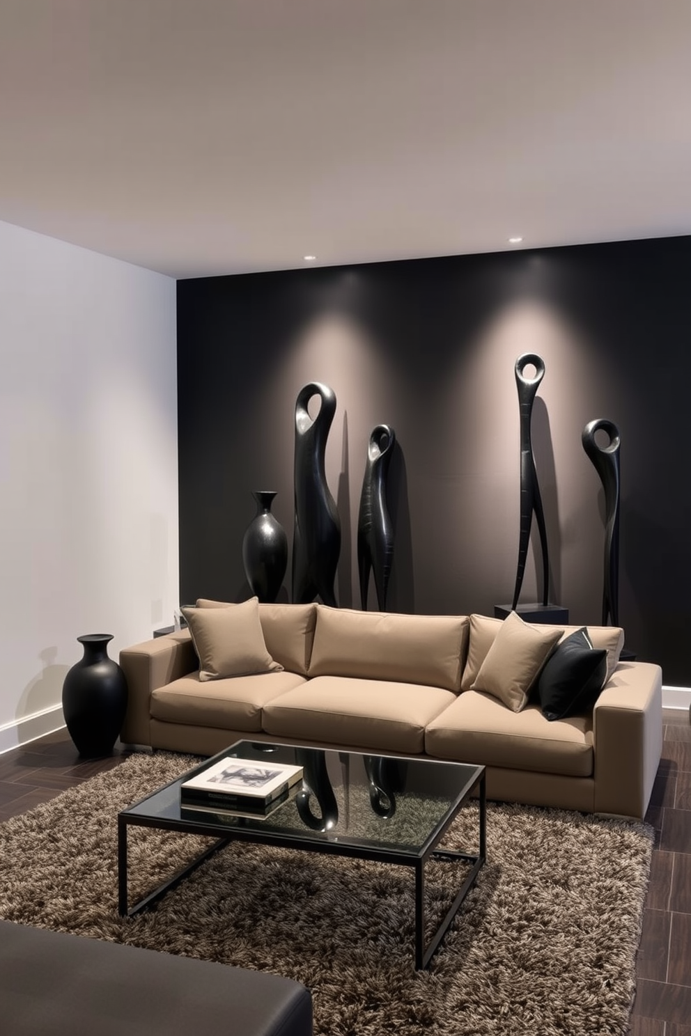 Artistic black sculptures serve as striking focal points in a modern basement design. The space features sleek black walls complemented by soft ambient lighting that highlights the sculptures' unique shapes and textures. The furniture is minimalistic, with a low-profile sectional sofa in a neutral color to balance the boldness of the artwork. A contemporary coffee table in glass and metal adds a touch of elegance, while a plush area rug anchors the seating area.