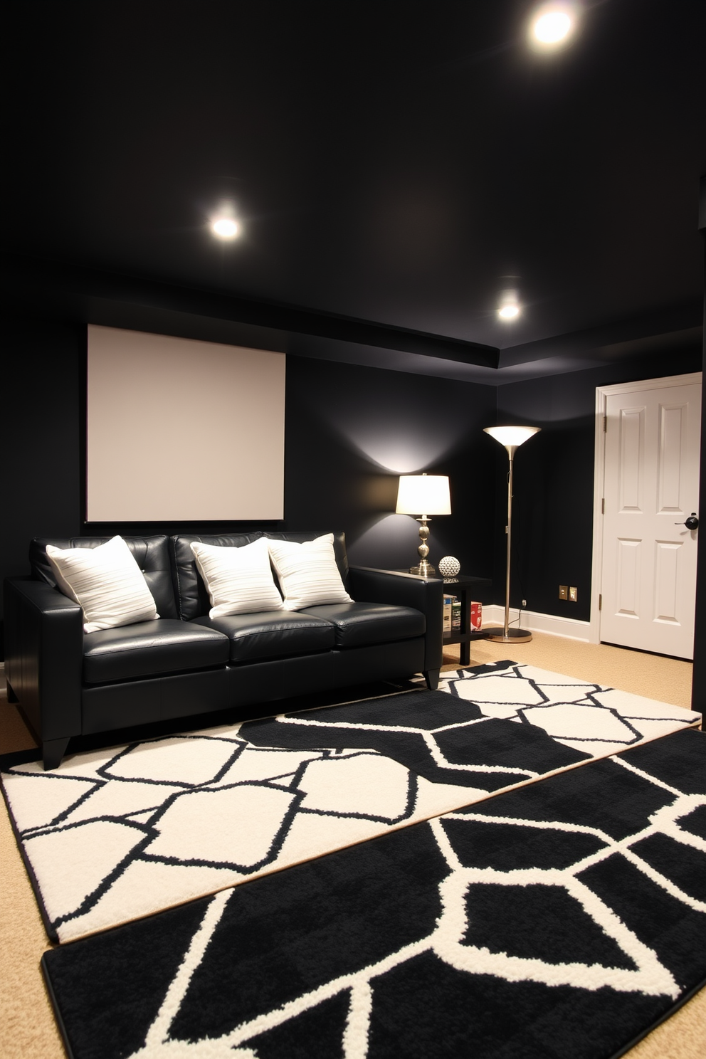 A stylish basement designed in a modern aesthetic. The space features a black and white geometric area rug that adds a bold contrast to the dark walls and furniture. The seating area includes a sleek black leather sofa paired with white accent pillows. Ambient lighting is provided by recessed ceiling lights and a contemporary floor lamp.