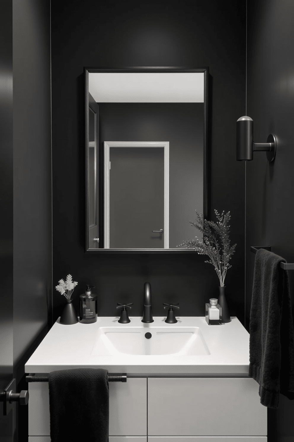 A sleek black bathroom featuring stylish accessories that add a modern touch. The space includes matte black faucets and hardware complemented by elegant black towels and decorative elements. The walls are adorned with deep charcoal paint, creating a bold backdrop for the design. A black-framed mirror hangs above a minimalist vanity, enhancing the sophisticated atmosphere of the room.