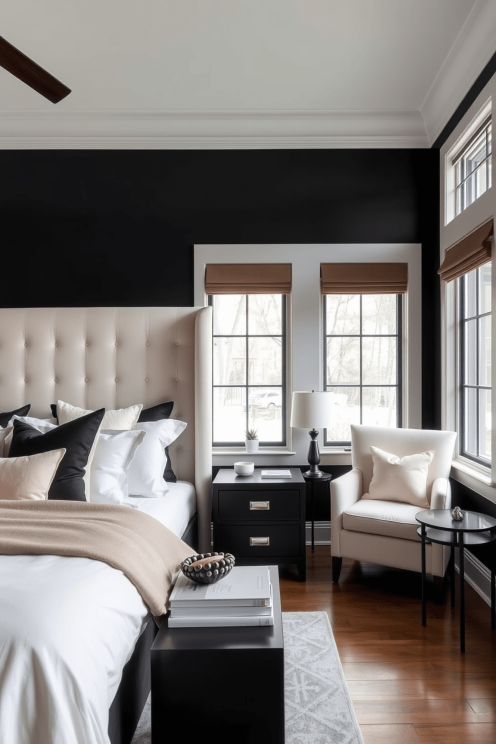 A serene black bedroom design featuring a plush cream upholstered headboard against a matte black accent wall. The bedding is layered with soft cream and black throw pillows, complemented by a sleek black nightstand with a minimalist lamp. A cozy reading nook is created in one corner with a cream armchair and a small black side table. Large windows allow natural light to filter in, illuminating the room's soft textures and inviting atmosphere.