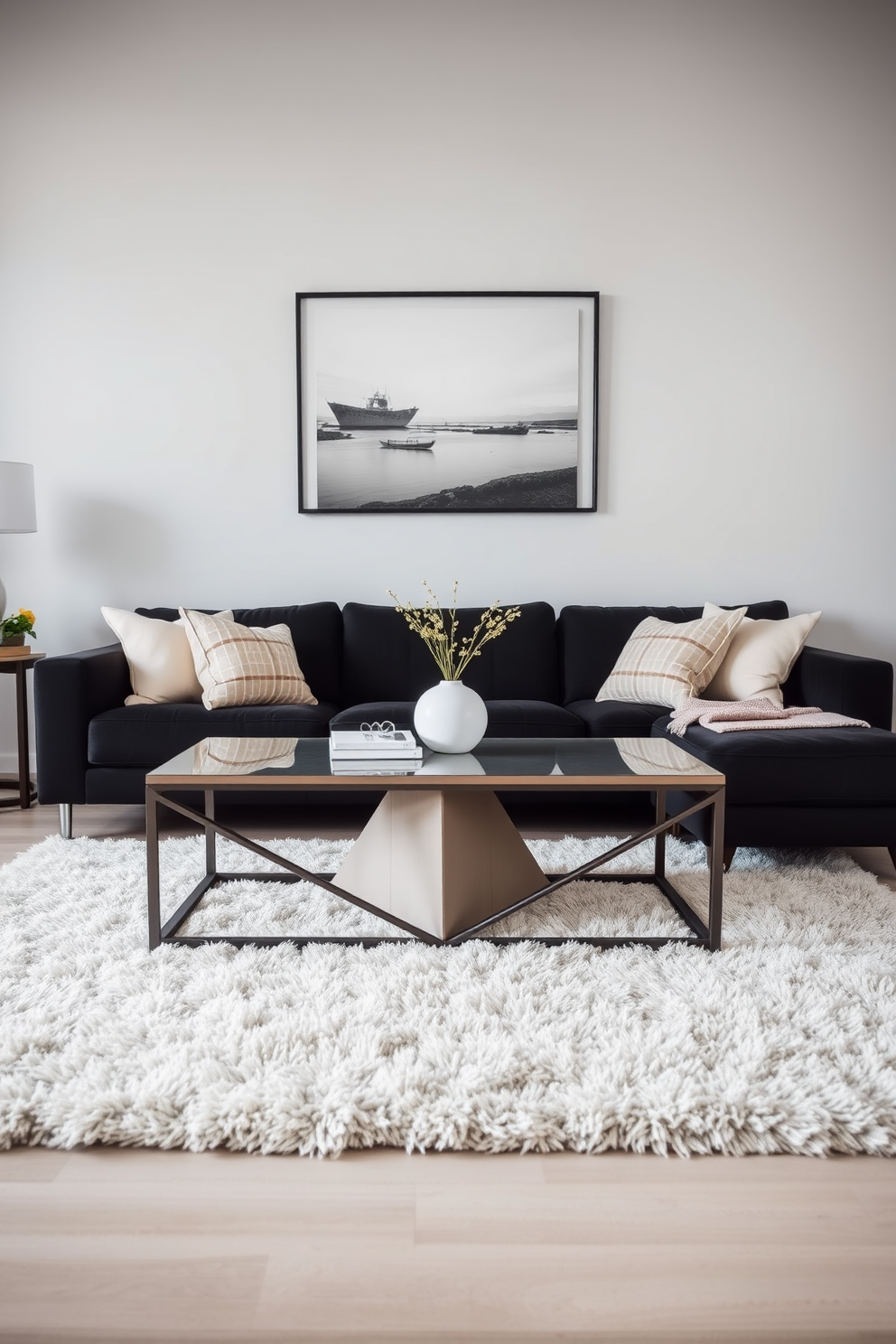 A stylish living room featuring a black couch as the focal point. In the center, there is a coffee table with a unique geometric design that complements the modern aesthetic. The walls are painted in a soft gray, creating a serene backdrop for the space. Plush area rugs in neutral tones add warmth underfoot while accentuating the contemporary decor.