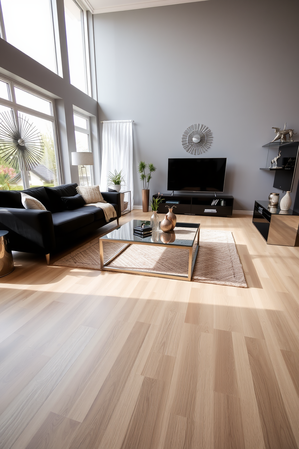 A modern living room with sleek lines and a black couch as the centerpiece. The space features metallic decor accents, including a stylish coffee table and decorative wall art that enhance the contemporary aesthetic. Large windows allow natural light to flood the room, creating a warm and inviting atmosphere. The walls are painted in a soft gray tone, complementing the bold black couch and metallic elements throughout the space.