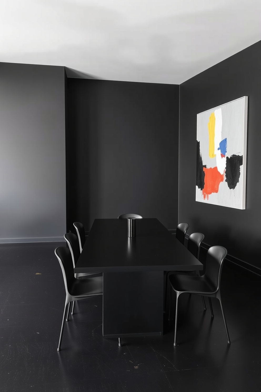 A minimalist dining room featuring clean lines and a sleek black color palette. The room includes a long rectangular dining table surrounded by simple, modern chairs with no embellishments. The walls are painted in a deep matte black, creating a dramatic backdrop. A large abstract artwork in contrasting colors hangs on one wall, adding a focal point to the space.