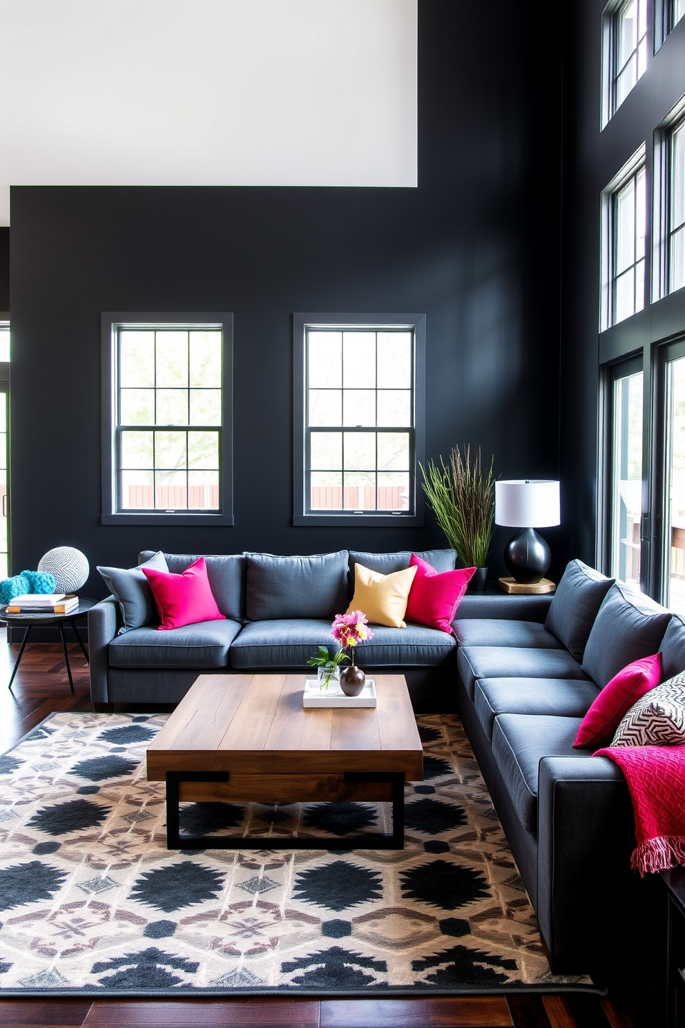 A striking family room features an accent wall painted in matte black, creating a bold focal point. The room is furnished with a plush sectional sofa in a deep gray fabric, complemented by vibrant throw pillows in jewel tones. Natural light floods the space through large windows, highlighting a sleek coffee table made of reclaimed wood. A stylish area rug with geometric patterns anchors the seating arrangement, adding warmth and texture to the room.