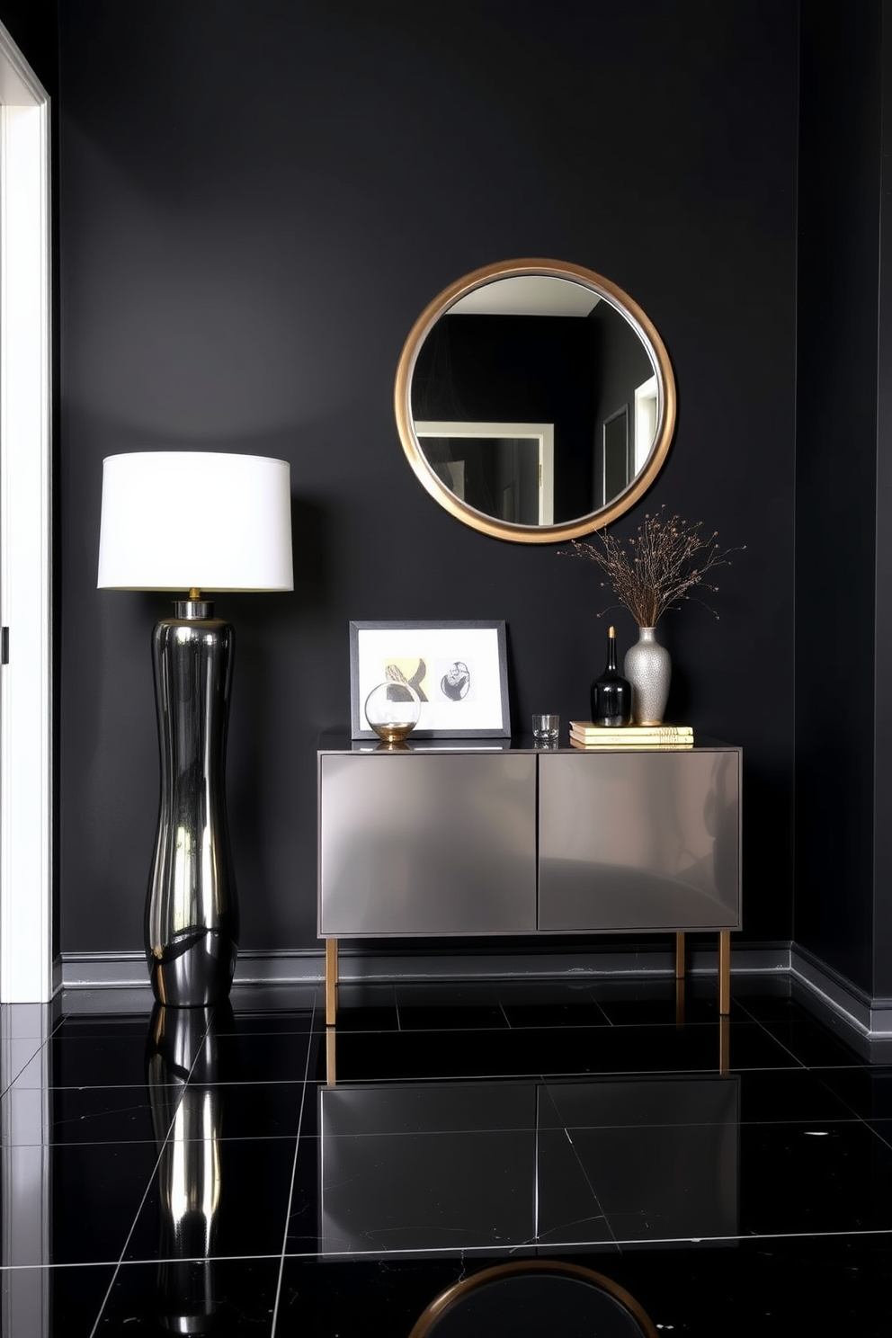 A striking foyer design featuring a bold black color scheme complemented by metallic accents. The walls are painted in a deep matte black, while a sleek metallic console table stands against one side, adorned with decorative objects and a stylish lamp. The floor is finished with glossy black tiles that reflect the light, enhancing the dramatic ambiance. A large round mirror with a metallic frame hangs above the console, creating a focal point and adding depth to the space.