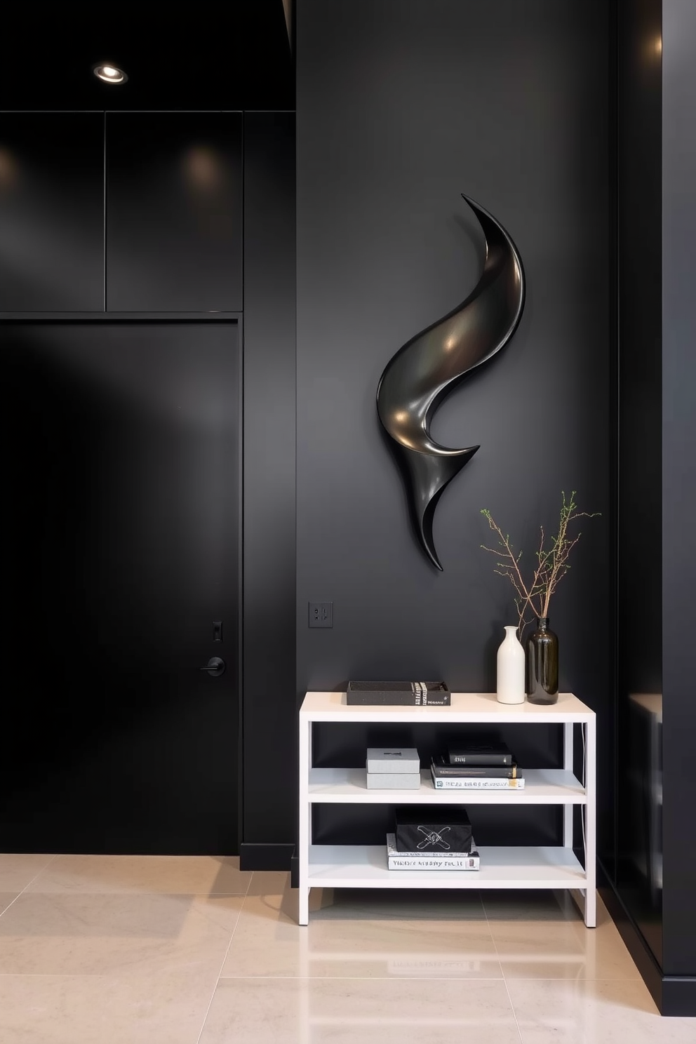 Artistic black sculpture as focal point. The foyer features sleek black walls that create a dramatic backdrop for the striking sculpture. A minimalist console table in a contrasting white finish sits against the wall, adorned with a few carefully curated decor pieces. Soft lighting from recessed fixtures highlights the sculpture, enhancing its artistic presence in the space.