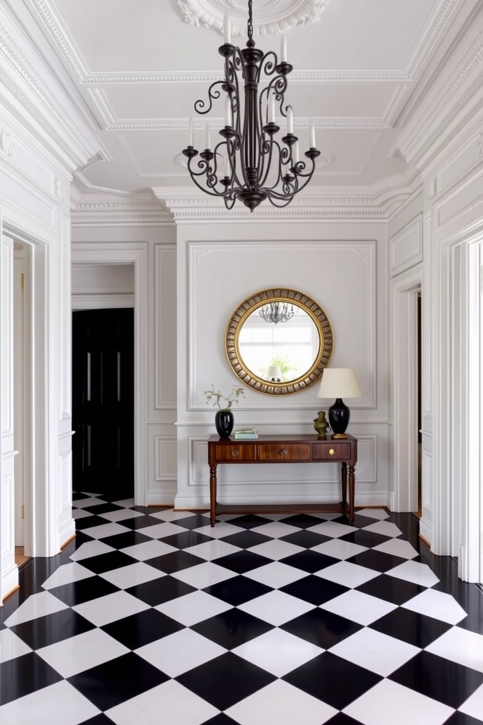 A classic black and white checkered floor sets the tone for an elegant foyer. The walls are adorned with intricate moldings and a stunning chandelier hangs from the ceiling, creating a grand entrance. A sleek console table in a rich wood finish is positioned against one wall. Above it, a large round mirror with a decorative frame reflects the light, enhancing the space's sophistication.