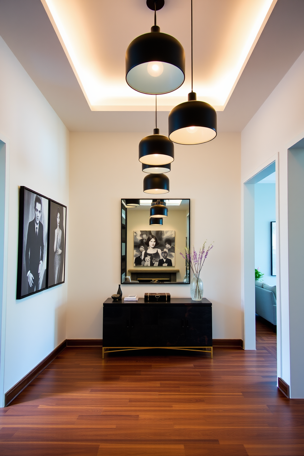 A stylish foyer features sleek black pendant lights hanging gracefully from the ceiling, casting a warm and inviting glow throughout the space. The walls are adorned with elegant artwork, and a chic console table adds functionality while enhancing the overall aesthetic. The flooring is a rich hardwood that complements the modern design, creating a seamless flow into the living area. A large mirror above the console table reflects the light, making the foyer feel more spacious and welcoming.