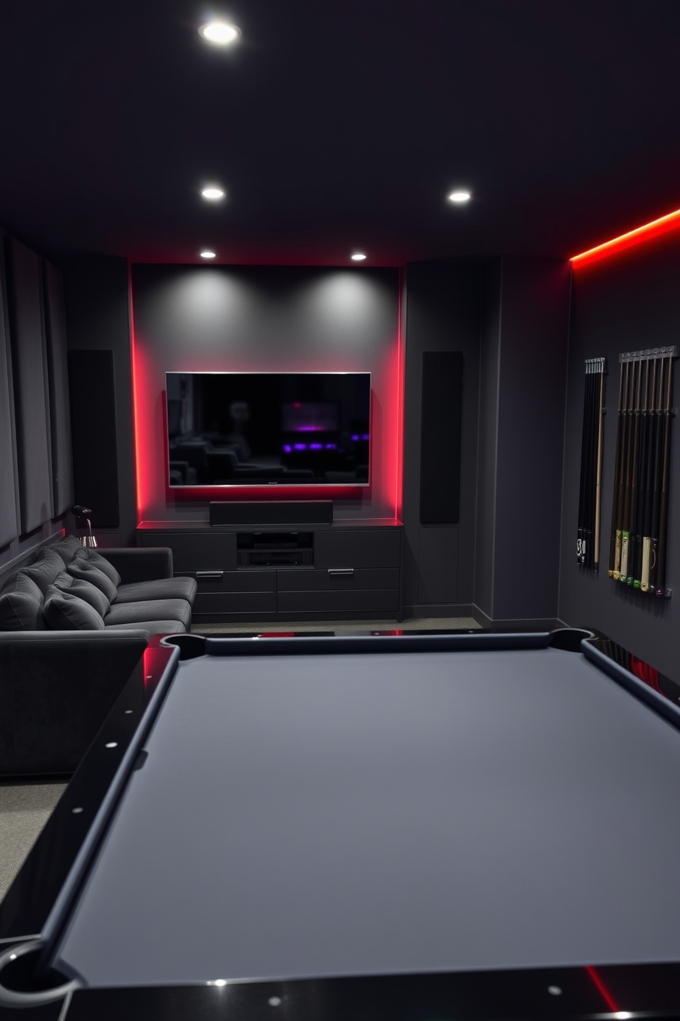 Custom built-in gaming nook design featuring a cozy L-shaped sectional sofa upholstered in dark velvet. The walls are adorned with soundproof panels in a deep shade of gray, and a large flat-screen TV is mounted above a sleek floating console. Black game room design ideas include a pool table with a glossy black finish and matching cues displayed on the wall. Ambient LED lighting in various colors highlights the room, creating an inviting atmosphere for entertaining friends.