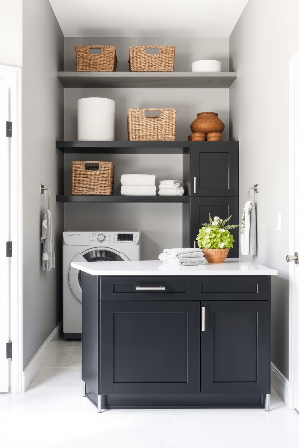 A sleek laundry island featuring black cabinetry takes center stage in a modern laundry room. The island is topped with a white quartz surface, providing ample space for folding clothes and organizing laundry essentials. The walls are painted in a soft gray tone, complementing the black cabinetry and creating a sophisticated atmosphere. Stylish open shelving above the island showcases neatly arranged baskets and decorative items, enhancing the room's functionality and aesthetic appeal.