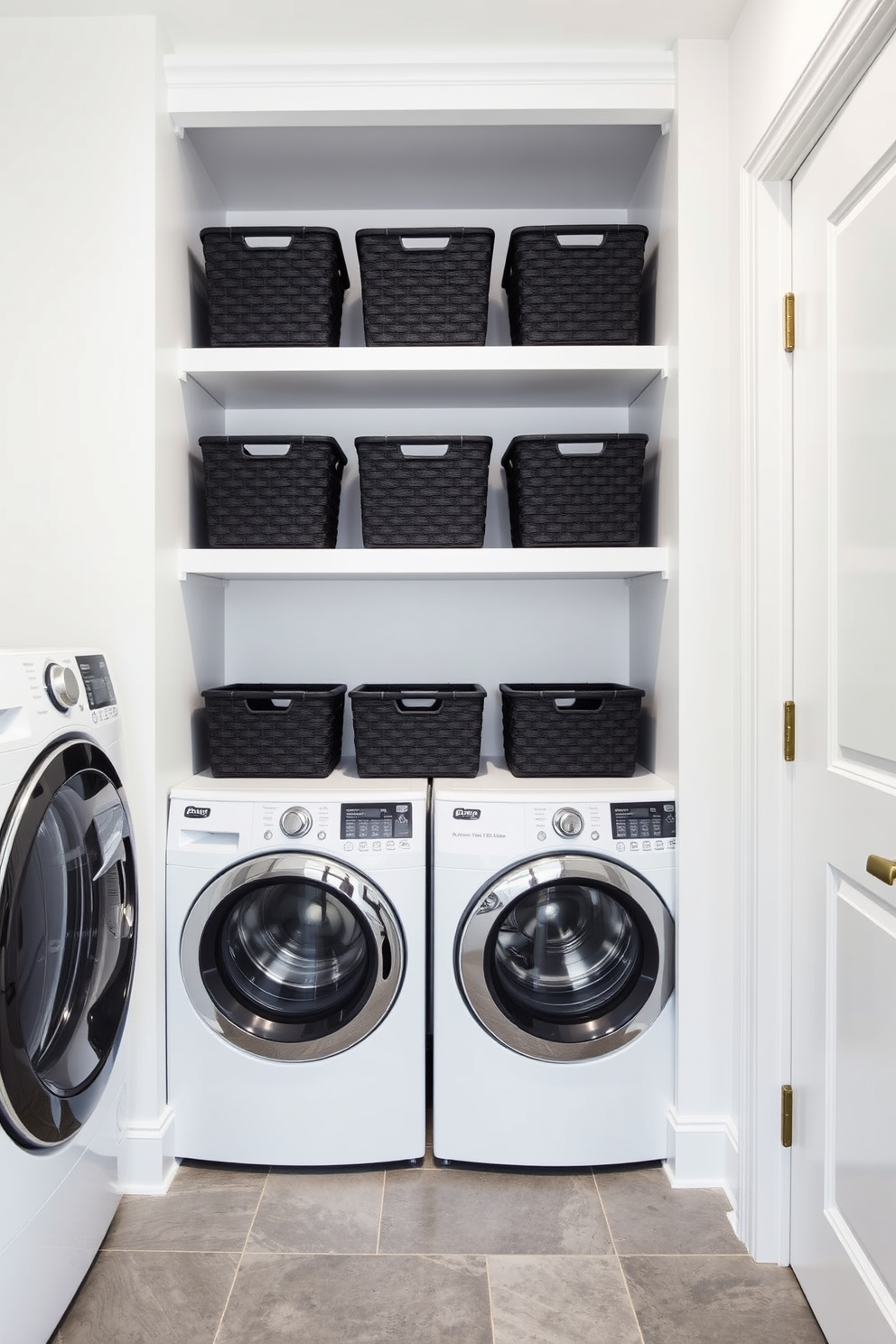 A modern laundry room featuring open shelving adorned with black baskets for storage. The walls are painted in a crisp white, creating a bright and airy atmosphere, while the floor is tiled in a sleek gray pattern.