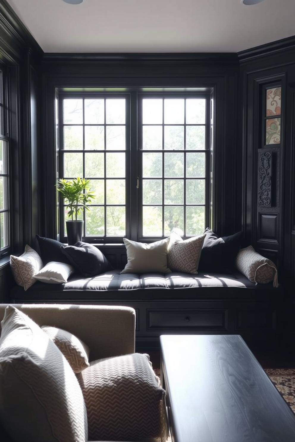 A cozy black living room features a cushioned black window seat adorned with soft pillows in various textures. Natural light pours in through large windows, creating a warm and inviting atmosphere.