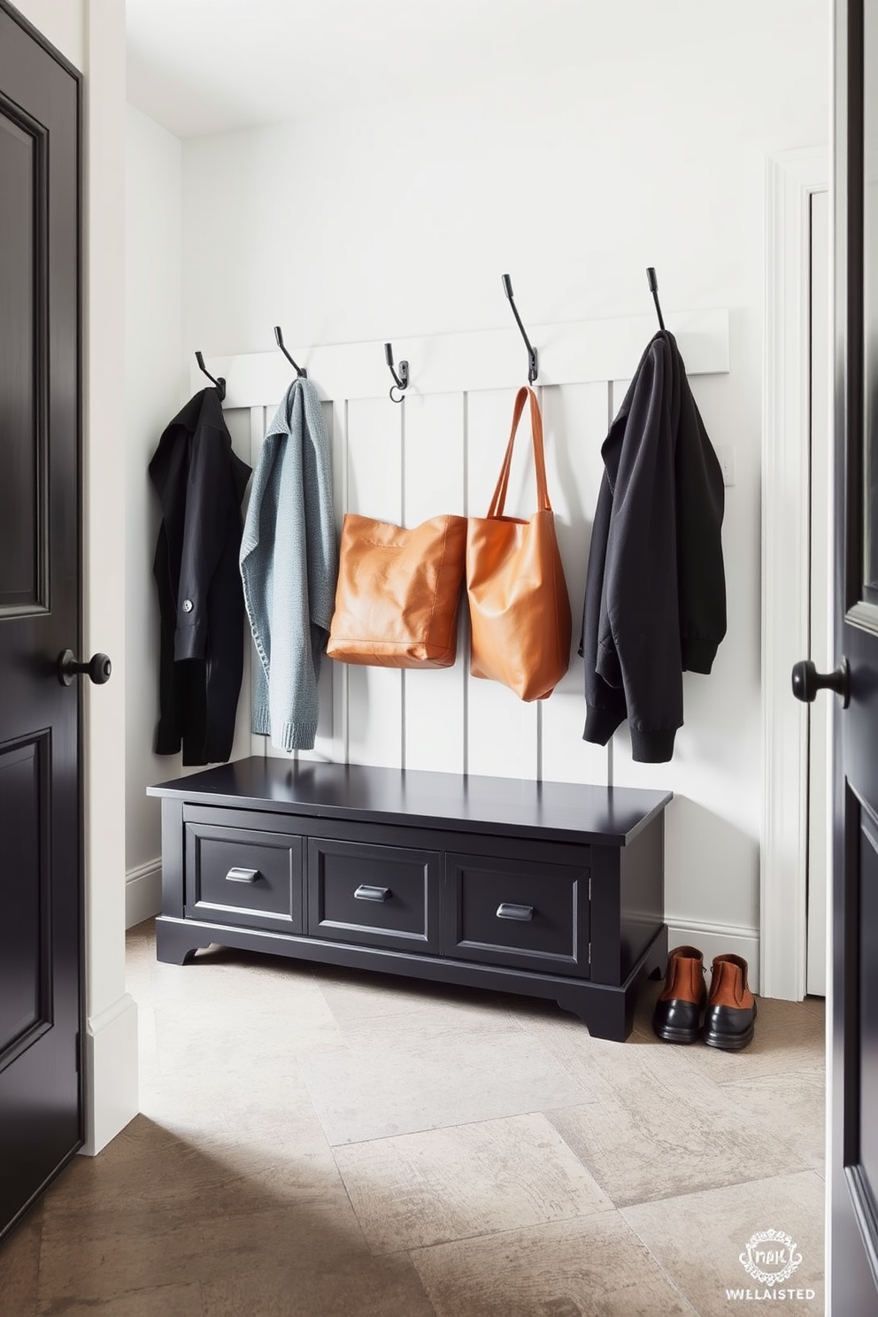 A functional black bench with hidden storage sits against the wall in a stylish mudroom. The space features hooks for coats and a durable floor that can withstand heavy foot traffic.