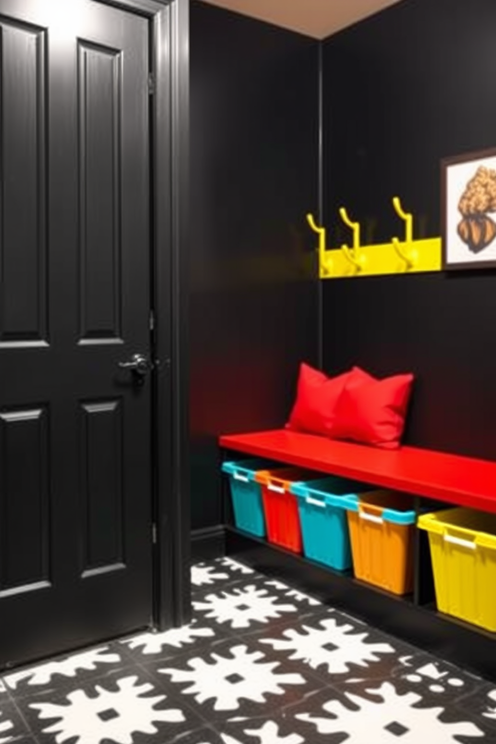 A stylish mudroom with a black backdrop creates a striking contrast with bright accents. The walls are painted matte black, while vibrant yellow hooks and a bold red bench add pops of color. The floor features a sleek black and white patterned tile that enhances the modern aesthetic. Brightly colored storage bins are neatly arranged, providing both functionality and a cheerful touch.