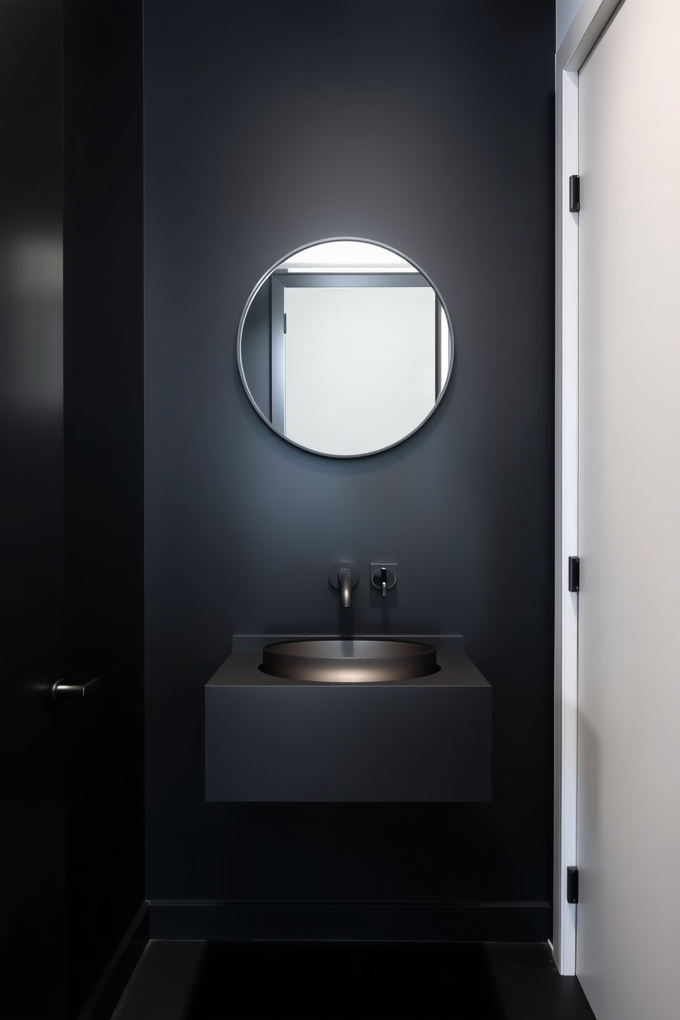 A minimalist black powder room featuring sleek black walls and a matte black floating vanity. The space includes a round mirror with a thin black frame and a wall-mounted black faucet above a simple black sink.