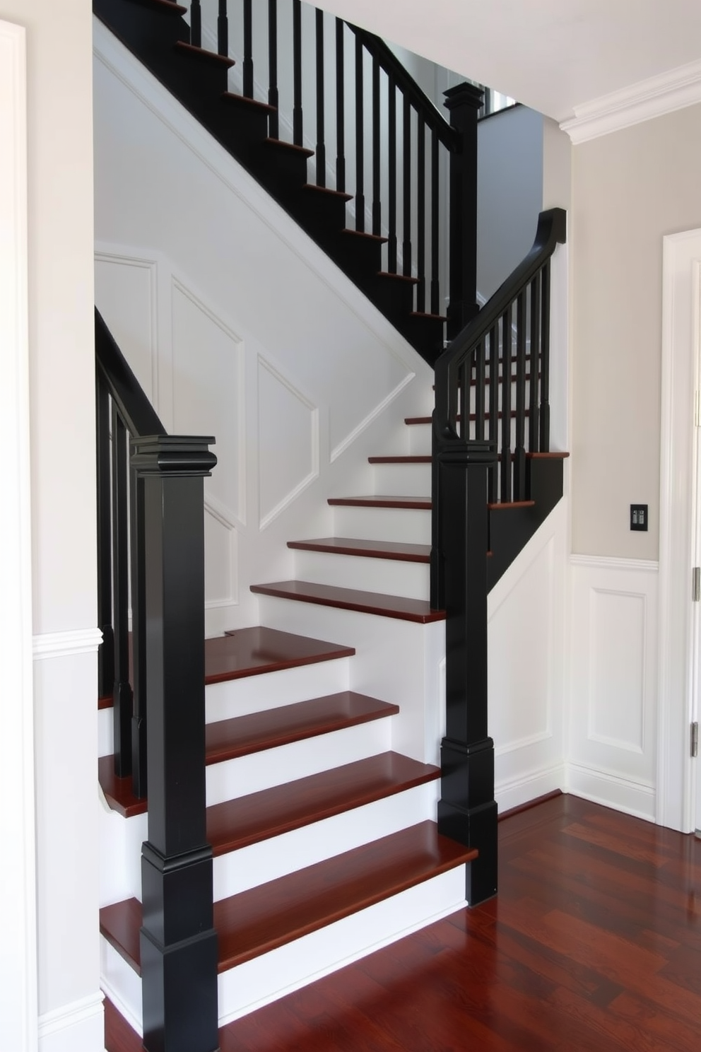 A classic black staircase with elegant white wainscoting creates a striking focal point in the entryway. The staircase features a sleek black railing that complements the rich dark wood of the steps, enhancing the overall sophistication of the space.