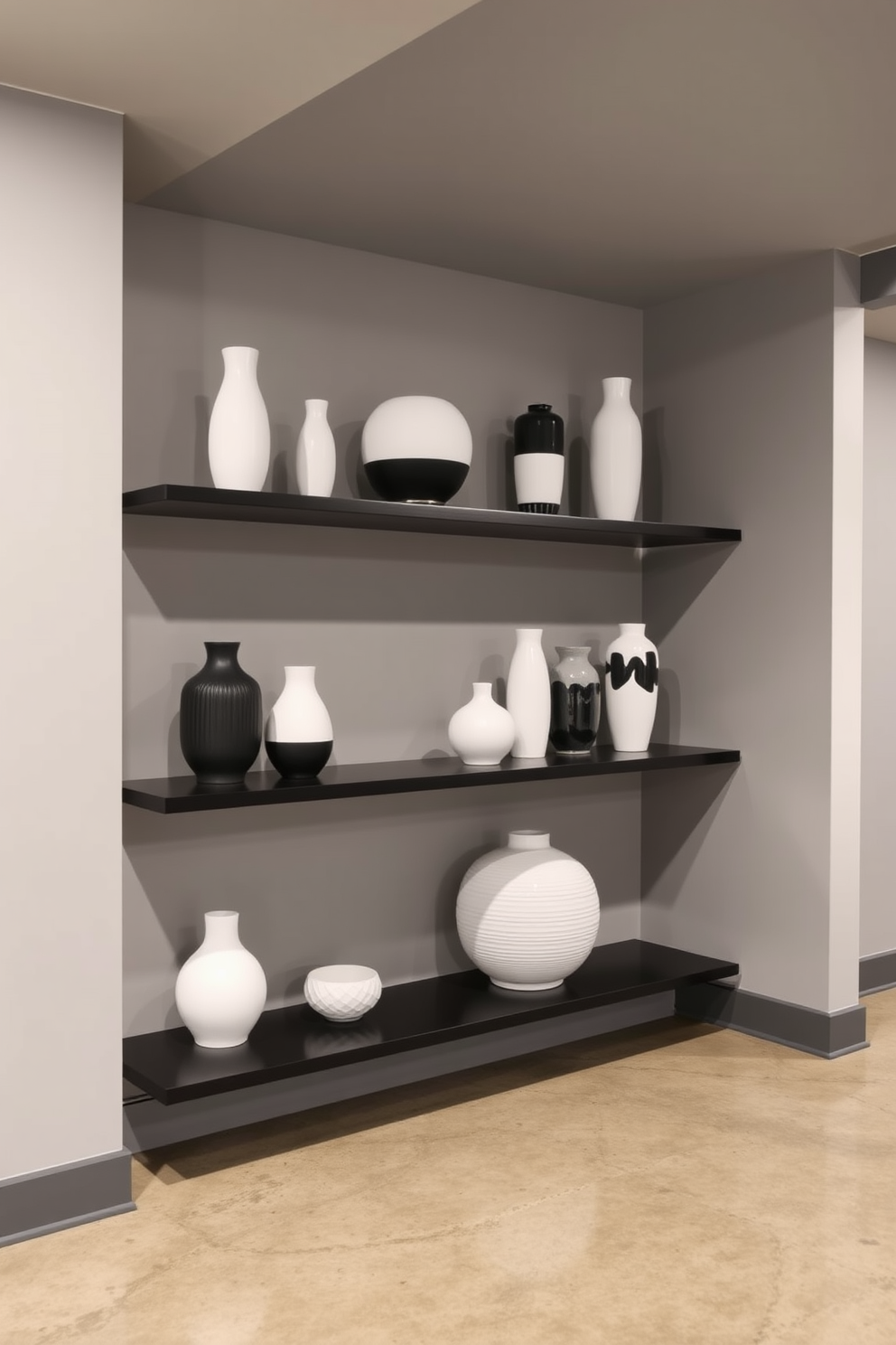 A stylish basement featuring black and white decorative vases arranged on sleek shelves. The walls are painted in a soft gray, and the flooring is a polished concrete that adds a modern touch.