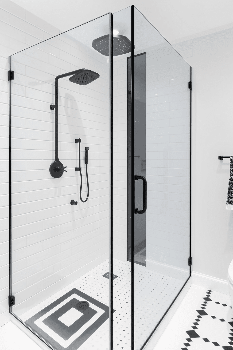 A sleek frameless glass shower features elegant black fixtures that create a striking contrast against the pristine white tiles. The overall design embraces a modern aesthetic with bold black and white elements, including geometric patterns on the floor and minimalist accessories.