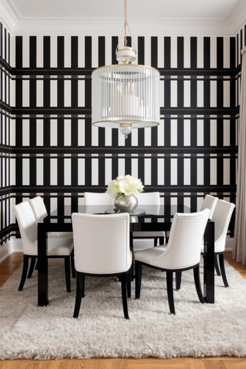 A chic dining room featuring elegant black and white striped wallpaper that creates a striking backdrop. The room is furnished with a sleek black dining table surrounded by white upholstered chairs, offering a sophisticated contrast. A large statement chandelier hangs above the table, adding a touch of glamour to the space. The floor is adorned with a plush area rug that complements the black and white theme, enhancing the overall elegance of the room.