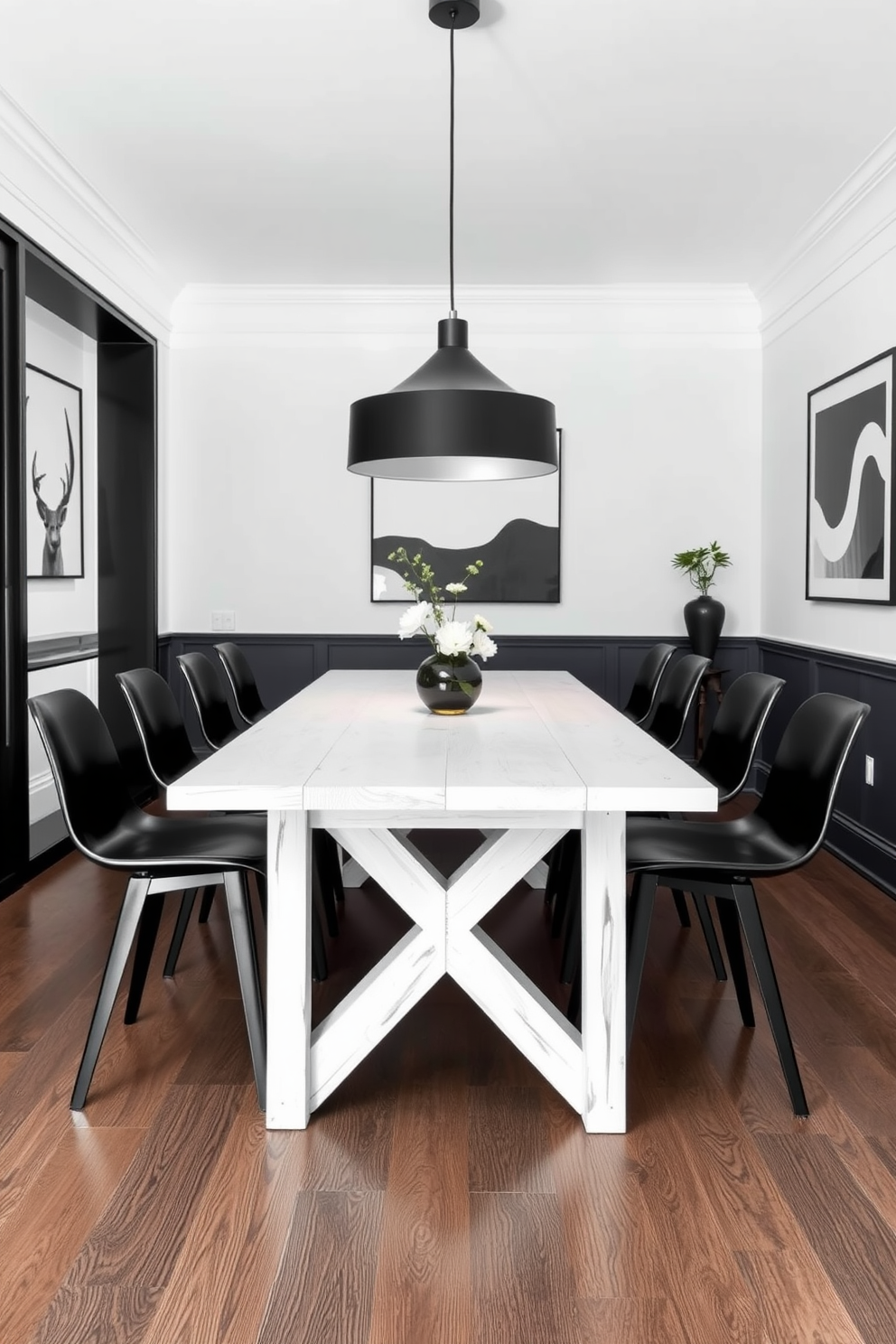 A whitewashed wood table is surrounded by sleek black stools, creating a striking contrast that enhances the modern aesthetic. The dining room features a minimalist design with black accents, including a bold light fixture hanging above the table and monochrome artwork adorning the walls.