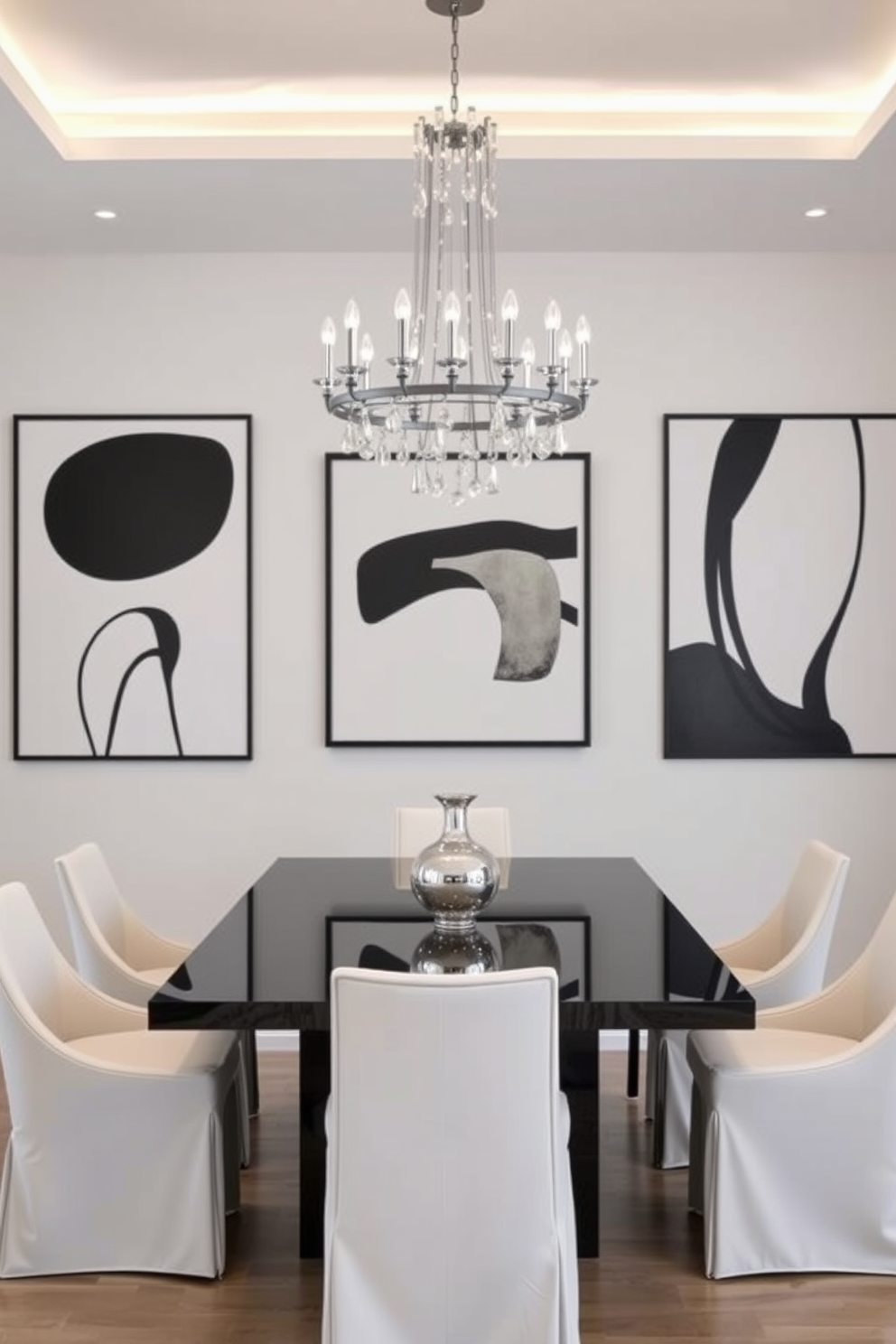 Artistic black and white wall art adorns the walls of a modern dining room, creating a striking focal point. The artwork features abstract shapes and bold lines that complement the minimalist aesthetic of the space. The dining table is a sleek black design surrounded by white upholstered chairs, adding contrast and elegance. A statement chandelier hangs above the table, casting soft light and enhancing the sophisticated ambiance.