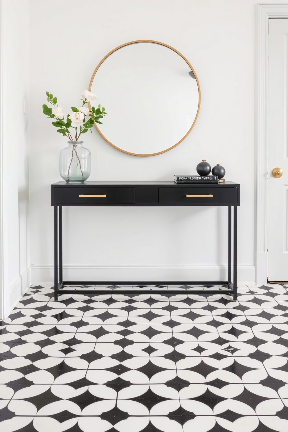 A sleek black console table with gold accents stands against a bright white wall in a stylish foyer. The floor features a striking black and white geometric patterned tile, enhancing the modern aesthetic of the space.