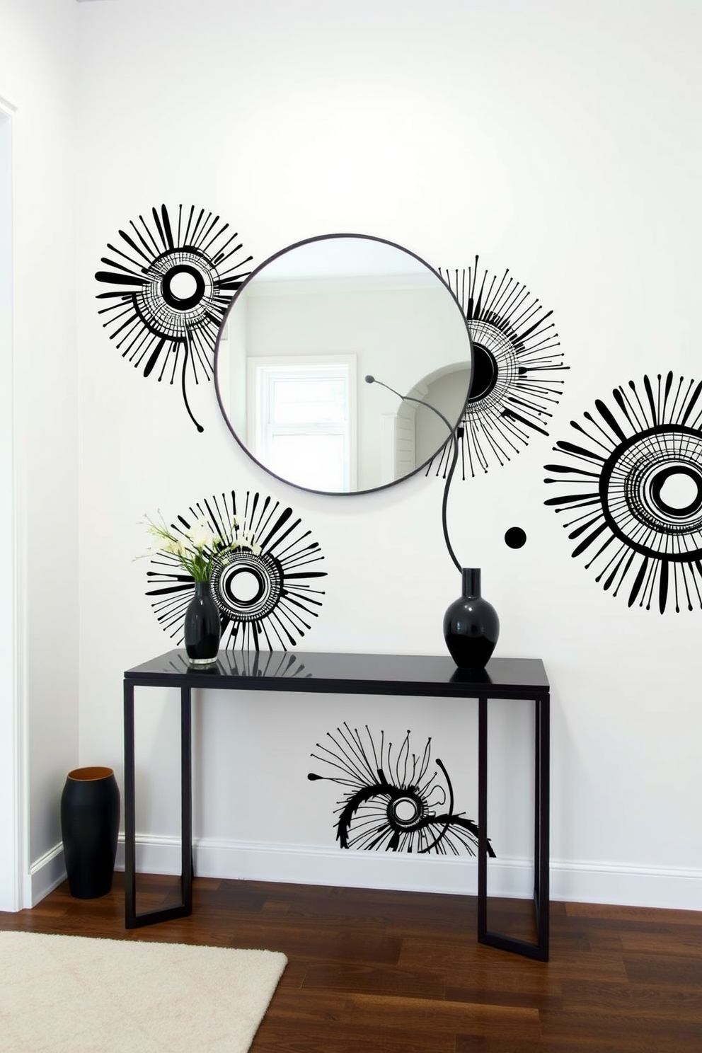 Artistic black and white wall decals create a striking focal point in the foyer. The decals feature abstract designs that enhance the modern aesthetic of the space. The foyer is designed with a sleek console table against a white wall. A large round mirror hangs above the table, reflecting the bold patterns of the wall decals.