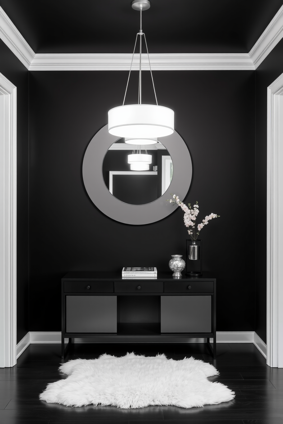 A striking white light fixture hangs from the ceiling against a dramatic black backdrop, creating a bold contrast that draws the eye. The foyer features a sleek black console table paired with a large round mirror, enhancing the modern aesthetic. The walls are painted in a deep matte black, providing a sophisticated canvas for the decor. A plush white area rug lies underfoot, adding warmth and texture to the space while complementing the overall black and white theme.