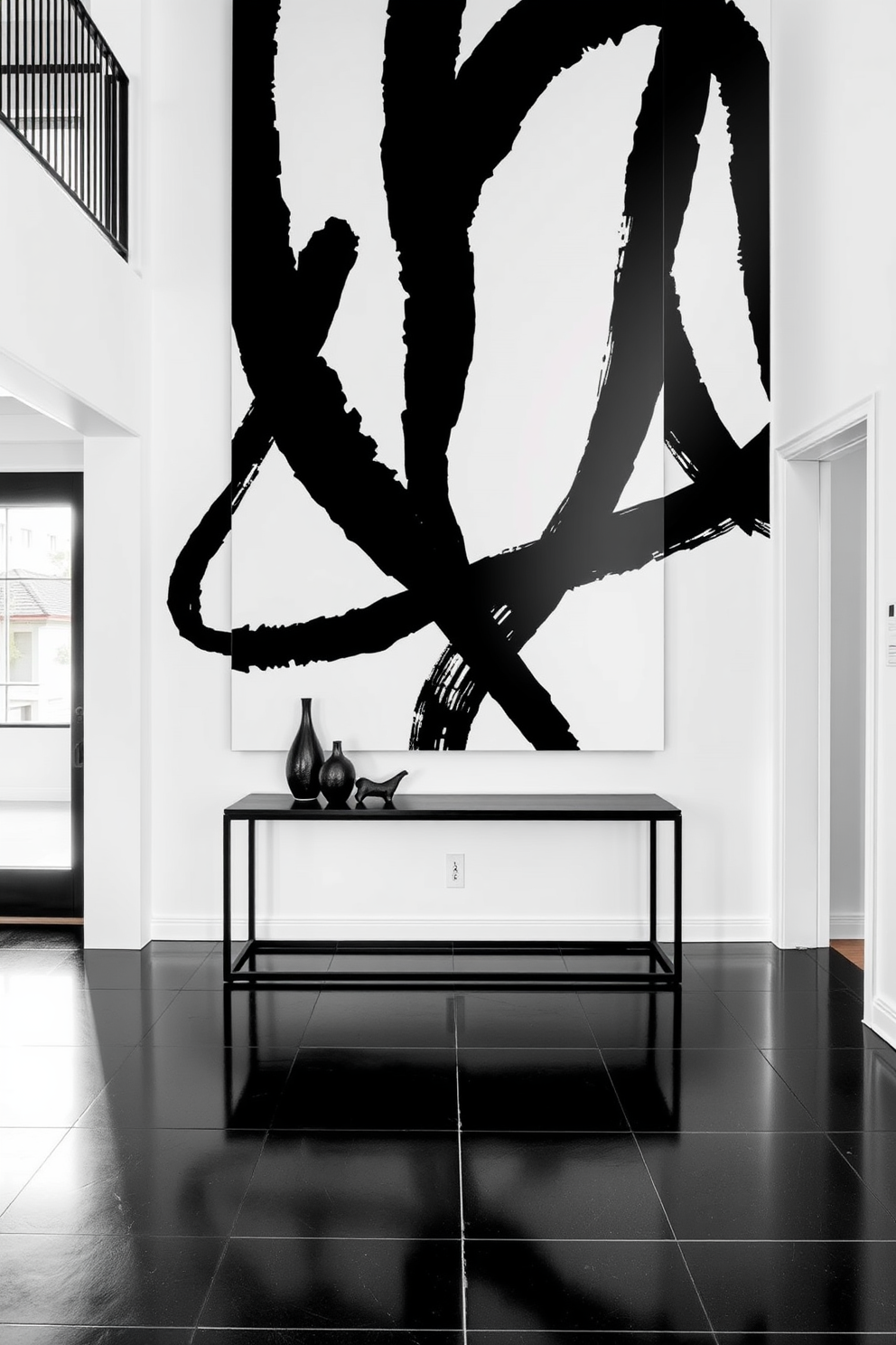 A striking foyer features a large black and white abstract art display that serves as the focal point of the room. The walls are painted in a soft white, allowing the bold artwork to stand out and create a modern, sophisticated atmosphere. The flooring consists of sleek black tiles that contrast beautifully with the light walls. A minimalist console table in black is positioned against the wall, adorned with a few decorative items in monochrome tones to enhance the overall aesthetic.