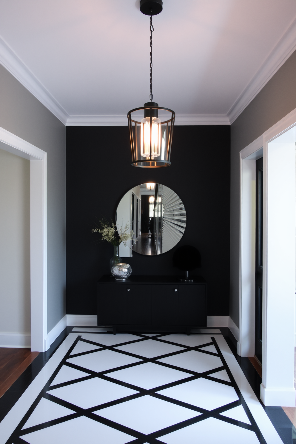 A stylish black pendant light fixture hangs gracefully from the ceiling, casting a warm glow over the entryway. The foyer features a striking black and white color scheme, with geometric patterns on the floor and a sleek console table against the wall.