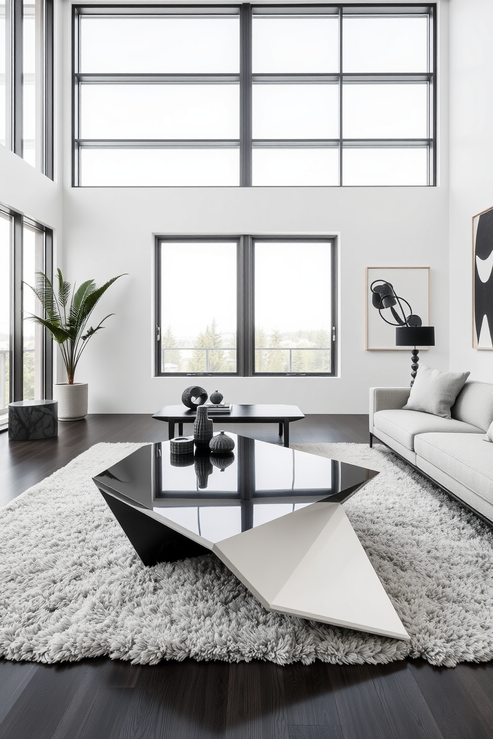 A sculptural coffee table in black and white sits at the center of a modern living room. The space features sleek furniture with bold geometric lines, complemented by a monochromatic color palette of soft grays and deep blacks. Large windows allow natural light to flood the room, highlighting the unique textures of the decor. A plush area rug anchors the seating arrangement, while abstract art pieces adorn the walls, adding visual interest to the sophisticated setting.