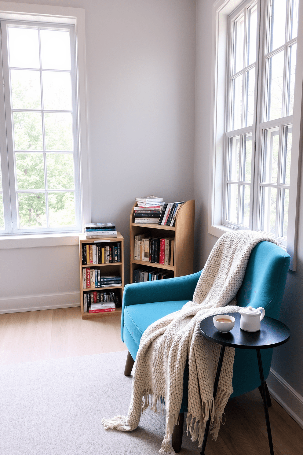 A cozy reading nook featuring an aqua blue accent chair positioned near a large window. The walls are adorned with light gray paint, and a small bookshelf filled with colorful books stands beside the chair. Natural light floods the space, creating a warm and inviting atmosphere. A soft, textured throw blanket drapes over the chair, and a minimalist side table holds a steaming cup of tea.