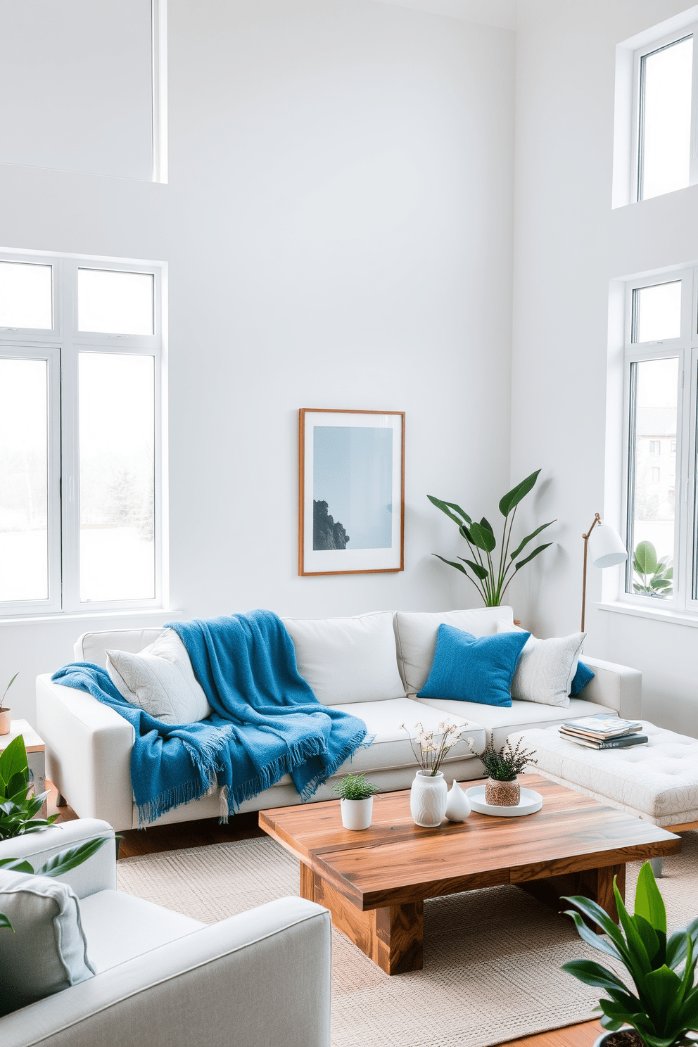 A cozy living room featuring a modern couch adorned with ocean blue throw blankets. The walls are painted in a soft white, and large windows allow natural light to flood the space, enhancing the serene atmosphere. The decor includes minimalist artwork and a chic coffee table made of reclaimed wood. Potted plants are strategically placed to bring a touch of nature indoors, complementing the calming color palette.