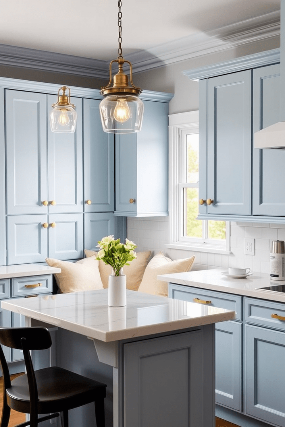 Light blue kitchen cabinets with brass handles create a serene and inviting atmosphere. The space features a white marble countertop that contrasts beautifully with the cabinetry. A cozy dining nook is positioned near a window, adorned with plush cushions that complement the blue tones. Pendant lights with a vintage design hang above the table, adding warmth and character to the room.