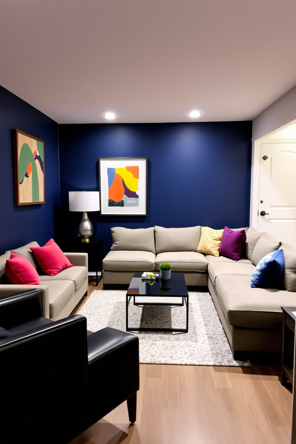 A dark blue accent wall serves as a striking backdrop for a stylish basement lounge area. The wall is adorned with contemporary artwork that adds a pop of color and personality to the space. The basement features a plush sectional sofa in neutral tones, complemented by vibrant throw pillows. A sleek coffee table sits in the center, surrounded by an area rug that ties the room together.