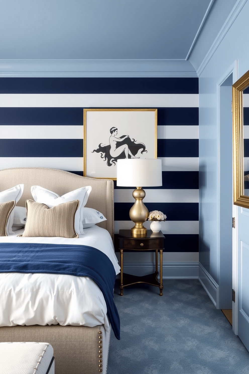 A serene blue bedroom featuring bold navy stripes on the feature wall creates a striking focal point. The room is adorned with soft white bedding and elegant gold accents to enhance the luxurious feel.