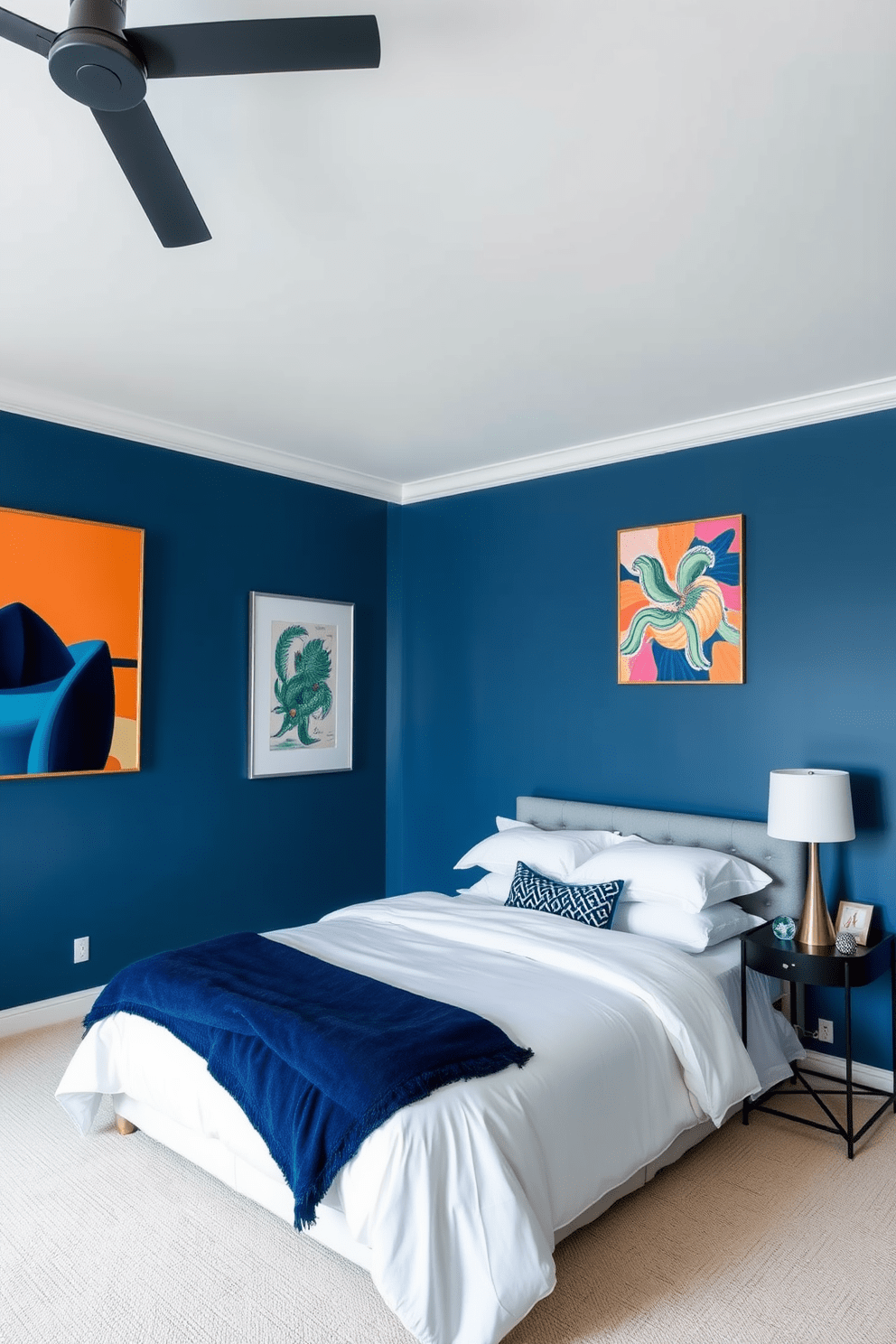 A serene blue bedroom featuring light navy walls that create a calming atmosphere. Bright artwork adorns the walls, adding vibrant splashes of color and personality to the space. The room includes a plush king-size bed dressed in crisp white linens and a soft navy throw blanket. A stylish nightstand with a modern lamp sits beside the bed, enhancing the overall elegance of the design.