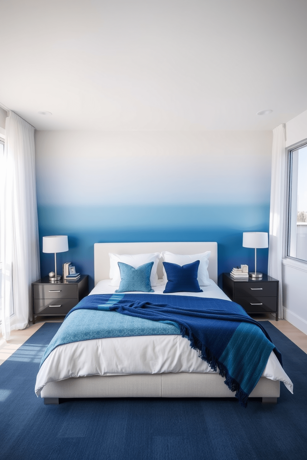 A serene blue ombre wall creates a modern touch in the bedroom, transitioning from a deep navy at the bottom to a soft sky blue at the top. The room features a plush king-sized bed with crisp white linens and an accent throw in various shades of blue, complemented by sleek nightstands on either side. Large windows allow natural light to flood the space, adorned with sheer white curtains that gently diffuse the sunlight. A minimalist desk in the corner boasts a stylish lamp and a few decorative items, enhancing the room's contemporary aesthetic.