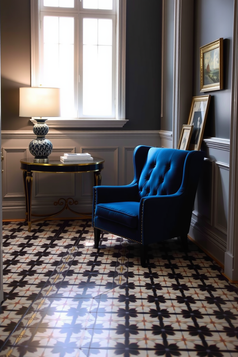 A deep blue accent chair is positioned in the corner of a stylish foyer. The walls are adorned with elegant wainscoting, and a decorative console table holds a chic lamp and a few art pieces. The floor features a striking patterned tile that complements the rich blue of the chair. Natural light floods the space through a large window, enhancing the inviting atmosphere of the foyer.