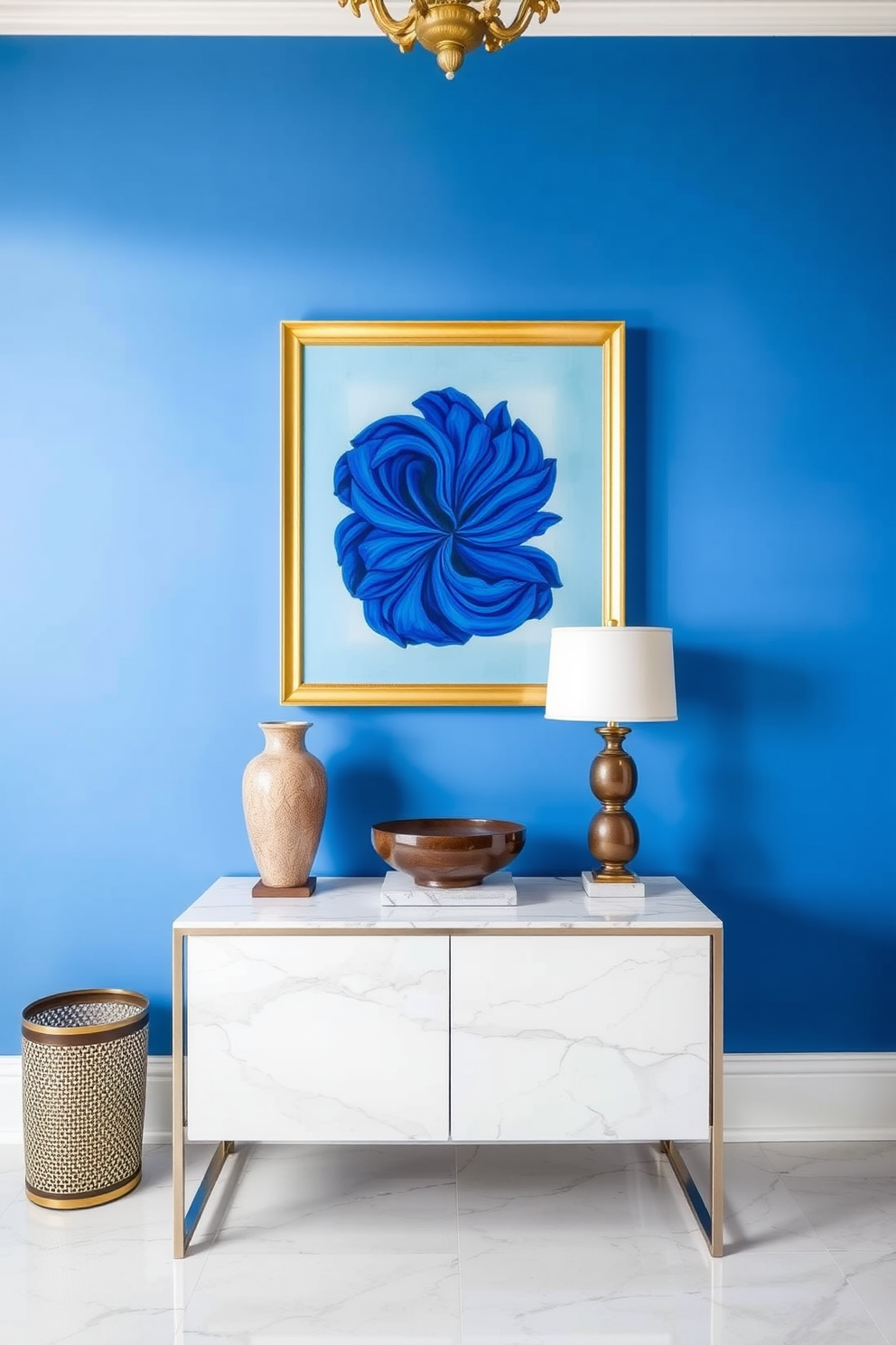 A stunning foyer featuring royal blue wall art elegantly framed in gold. The space is accentuated by a sleek console table with a marble top and decorative accents that complement the bold color scheme.