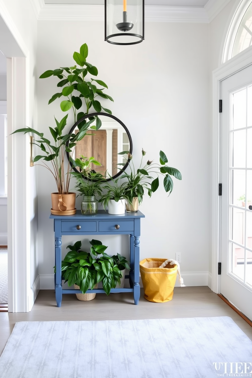 A stylish entryway features a slate blue entry table adorned with various lush green plants. The walls are painted in a soft white hue, creating a bright and inviting atmosphere. The floor is covered with a light gray rug that complements the blue table. Natural light streams in through a large window, enhancing the serene ambiance of the foyer.