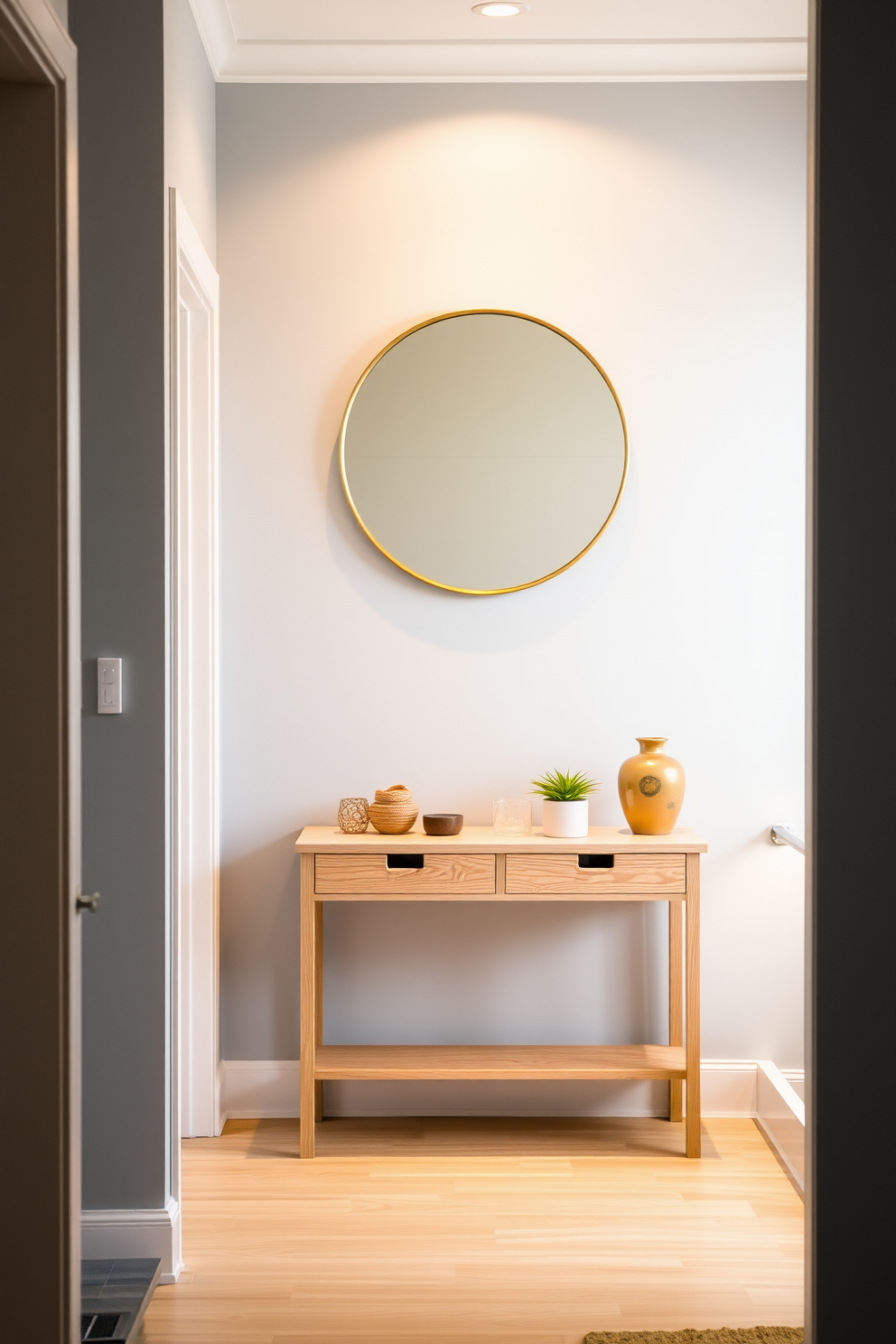 A serene foyer featuring soft denim blue walls that evoke a calm and inviting atmosphere. The space is illuminated by warm lighting, creating a cozy ambiance that welcomes guests. A stylish console table made of light wood is positioned against the wall, adorned with decorative items and a small potted plant. A large round mirror with a thin gold frame hangs above the table, reflecting the warm tones of the room.