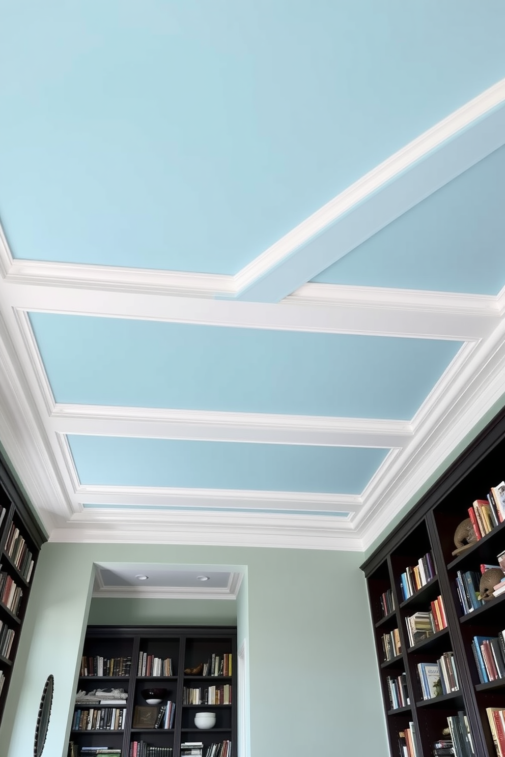 A serene home library featuring a sky blue ceiling adorned with elegant white crown molding. The space is filled with dark wooden bookshelves that reach the ceiling, showcasing a collection of books and decorative items.