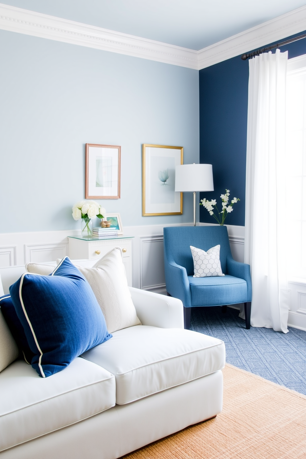 A coastal inspired blue and white decor features light blue walls adorned with white wainscoting. The space includes a comfortable white sofa with blue and navy throw pillows, complemented by a jute area rug that adds texture. For the blue home office design ideas, envision a serene workspace with navy blue accent walls and a large white desk. The room is filled with natural light from a window dressed with sheer white curtains, and a cozy reading nook with a blue armchair is tucked into the corner.