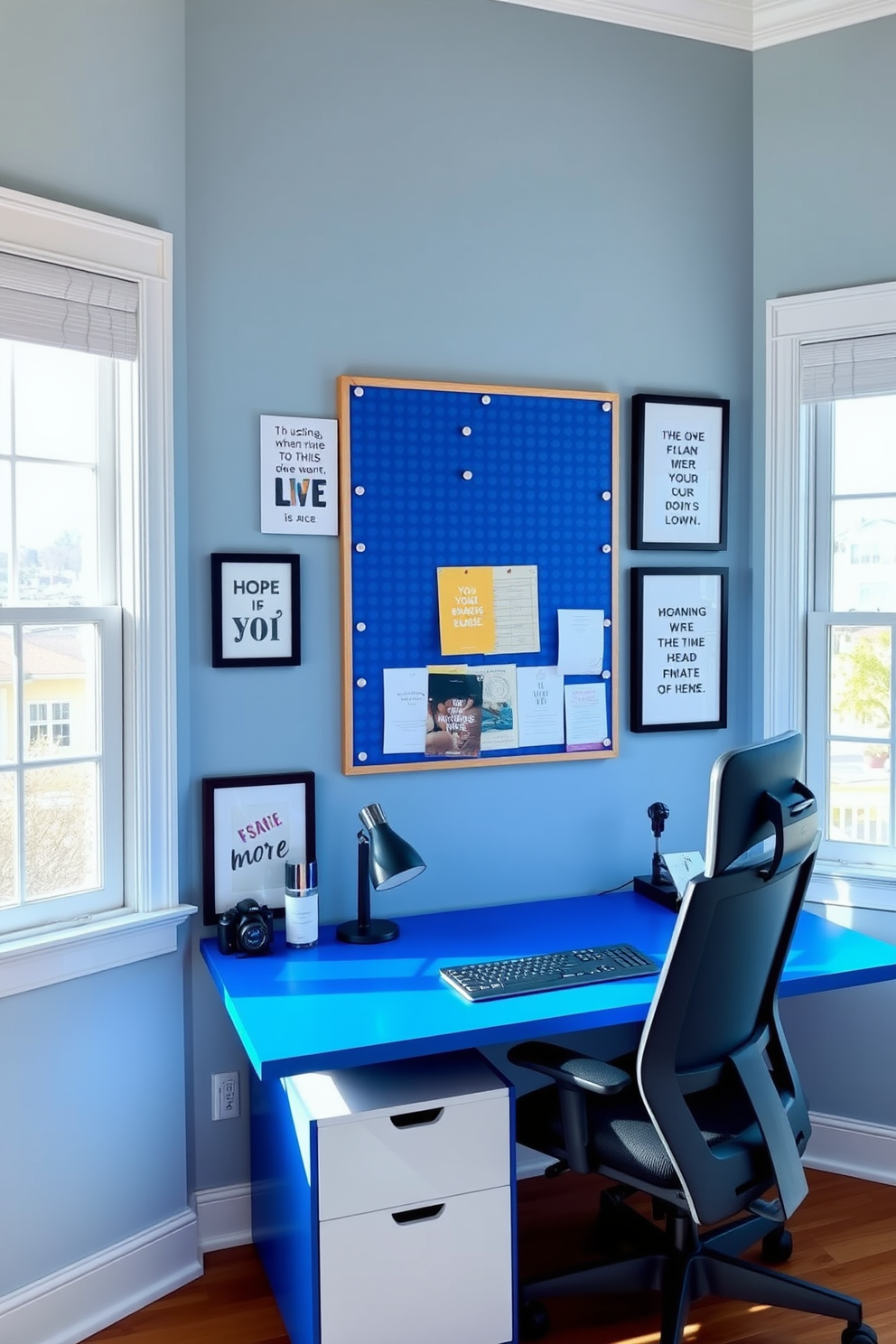 A blue pinboard is mounted on the wall, serving as a stylish organizational tool. It is surrounded by framed art and motivational quotes, creating an inspiring workspace. The home office features a sleek blue desk paired with a comfortable ergonomic chair. Large windows allow natural light to flood the room, enhancing the calming blue color palette.