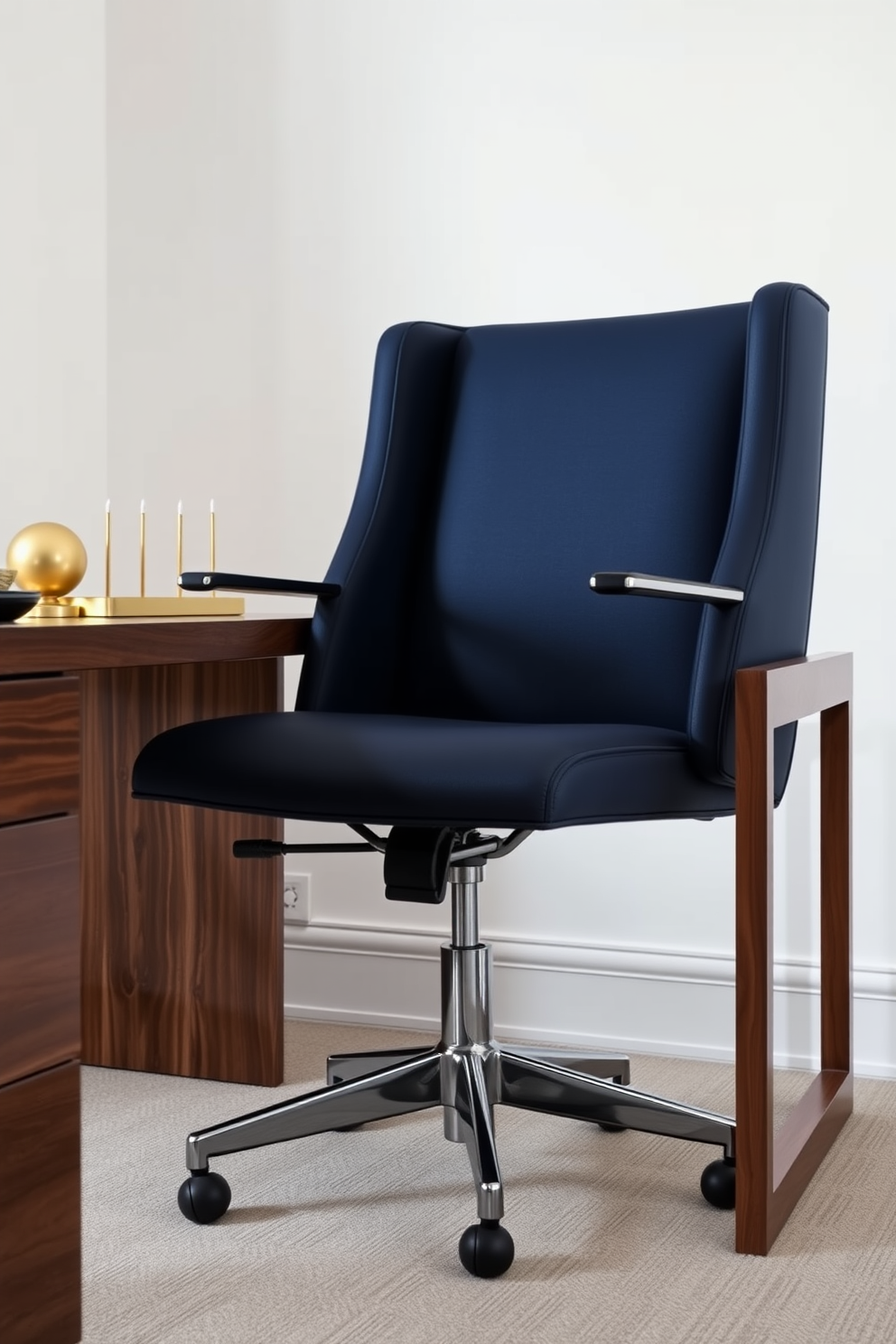 A navy blue office chair exudes elegance and sophistication in a modern workspace. The chair is paired with a sleek wooden desk that complements the deep blue tones. The walls are painted in a soft white, creating a bright and airy atmosphere. Accents of gold in the desk accessories add a touch of luxury to the overall design.